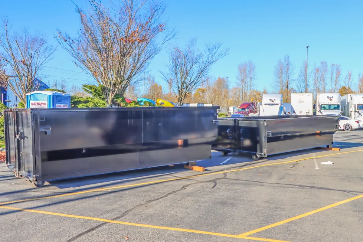 Professional dumpster rental service with roll-off container on residential driveway in West Whiteland